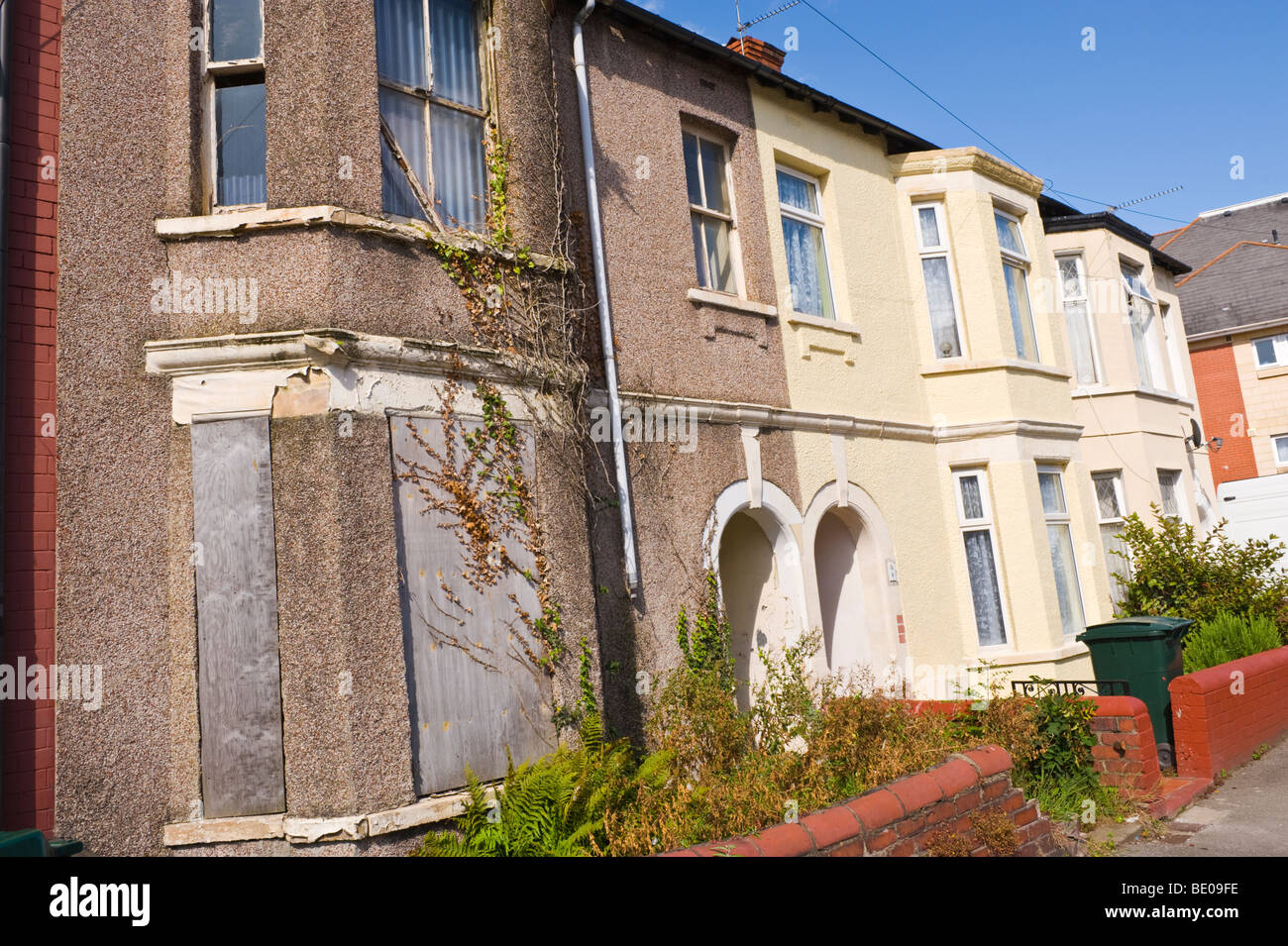 Derelict boarded up terraced house in Newport South Wales UK Stock Photo