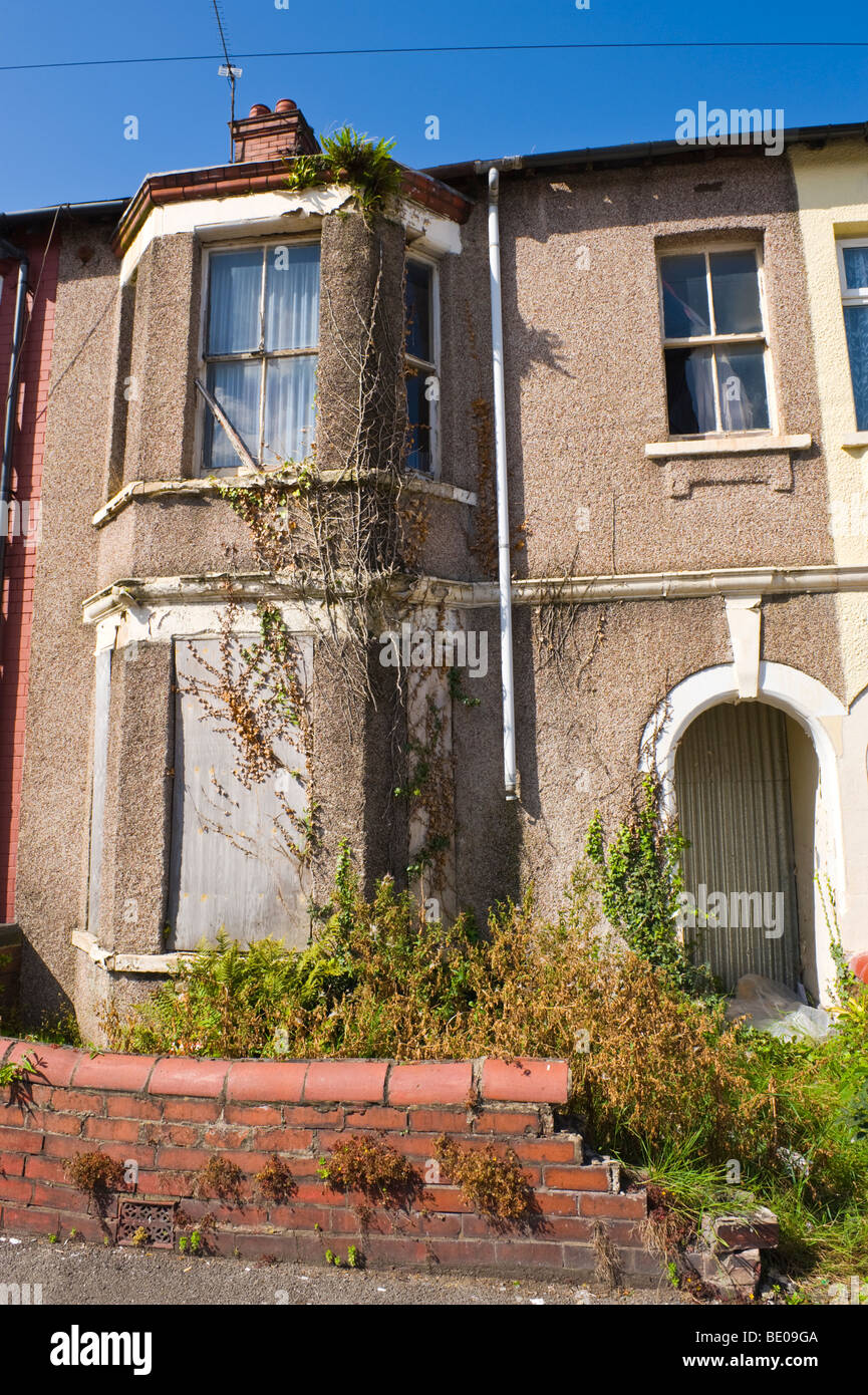 Derelict boarded up terraced house in Newport South Wales UK Stock Photo