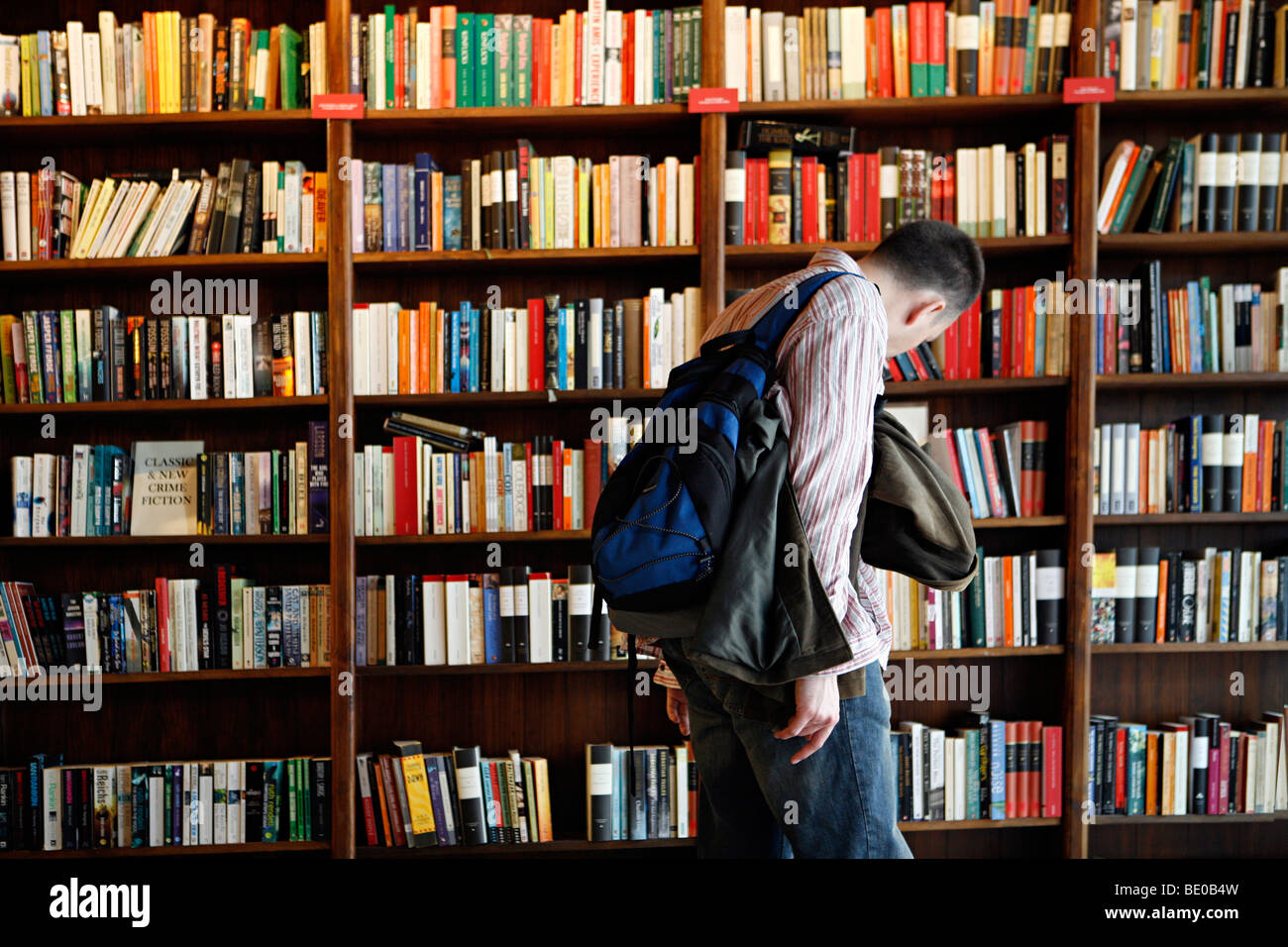 A man browsing in a book shop in a village called hay-on-wye. Stock Photo