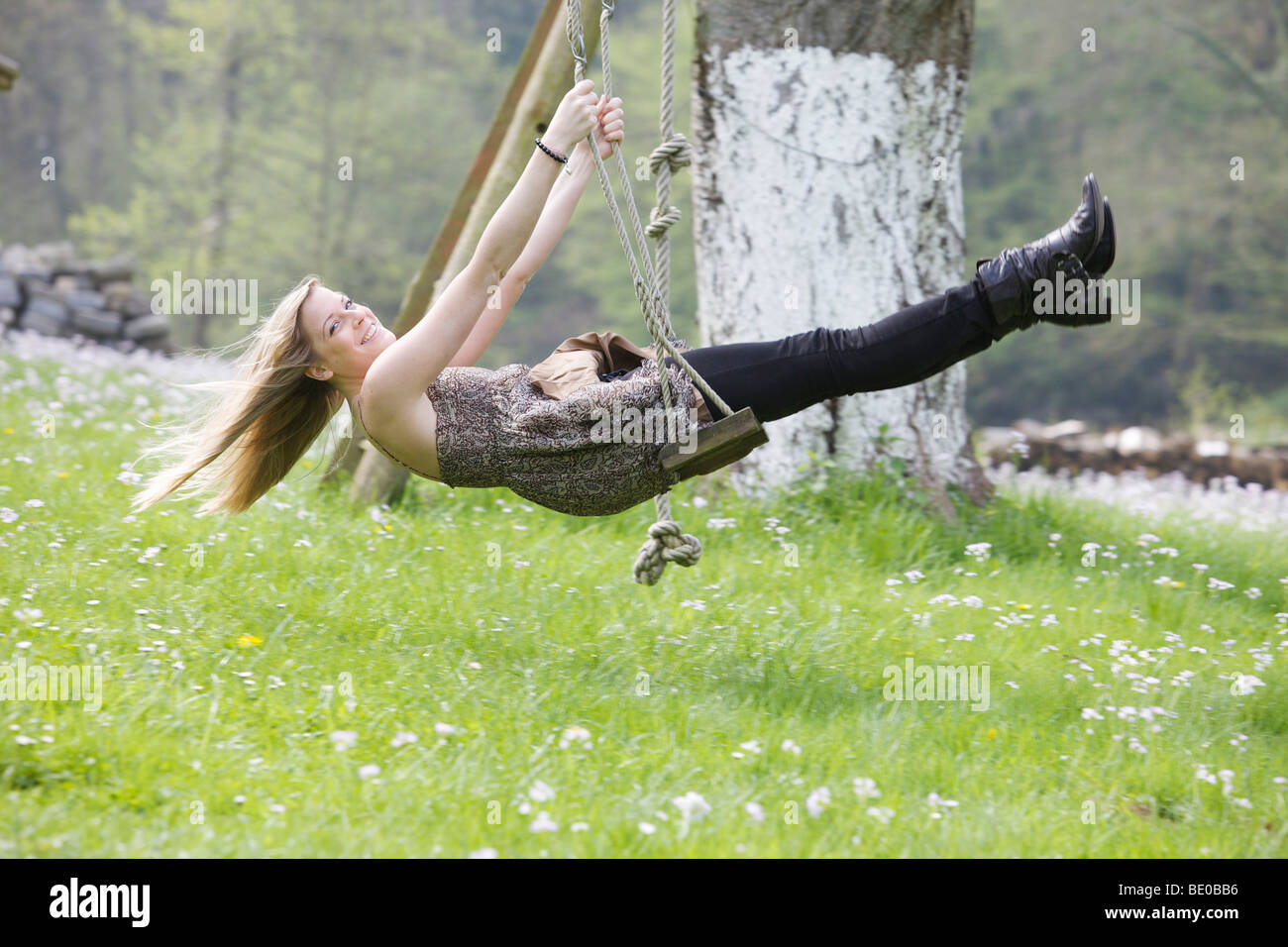 Girl sitting on a swing Stock Photo - Alamy