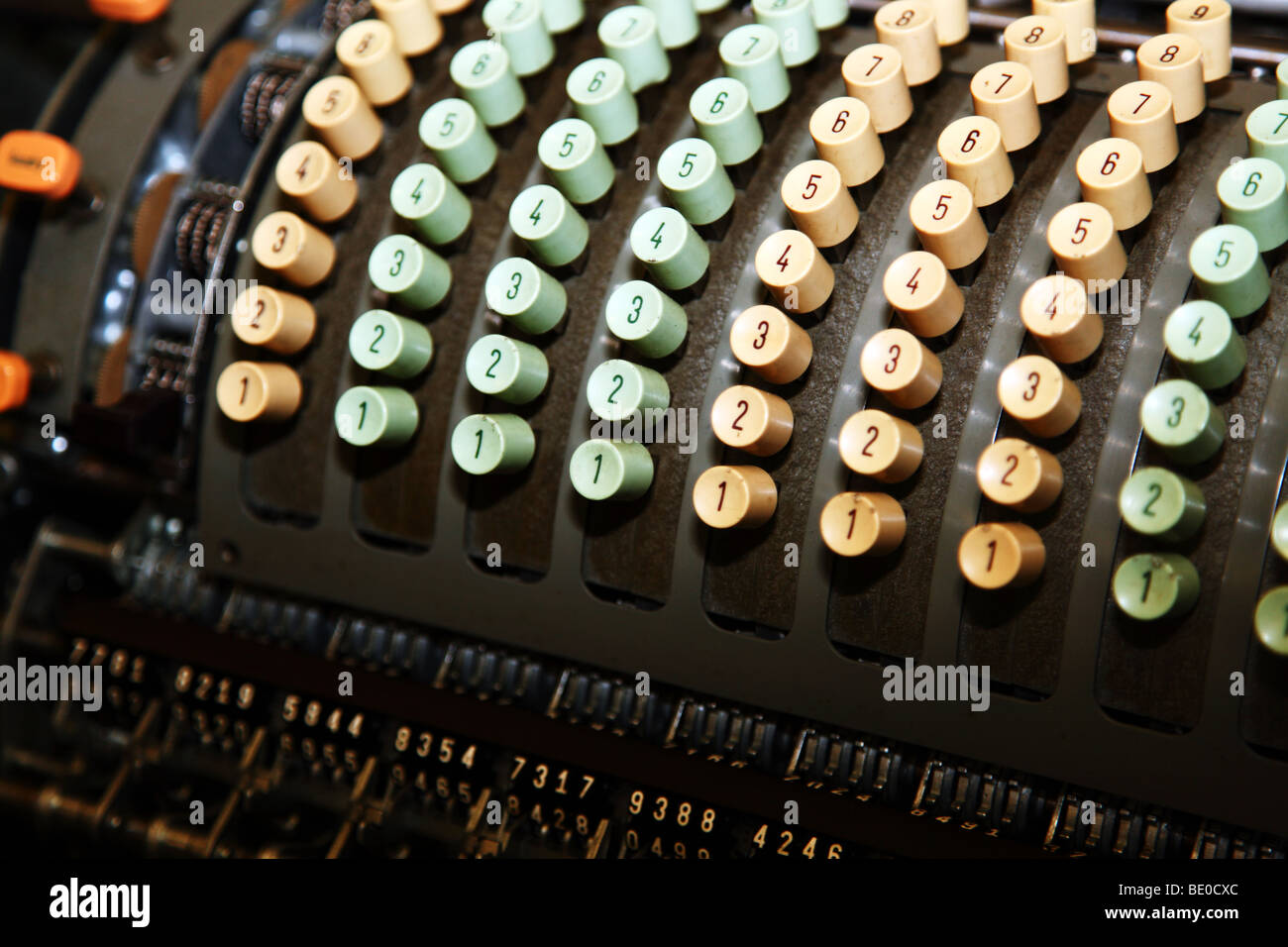 An old fashioned calculating machine with many rows of number keys ...
