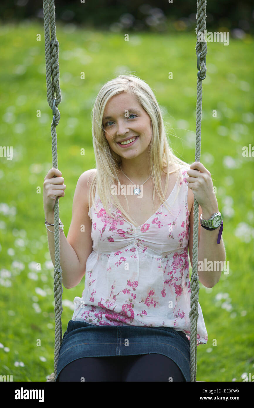 Girl sitting on a swing Stock Photo - Alamy