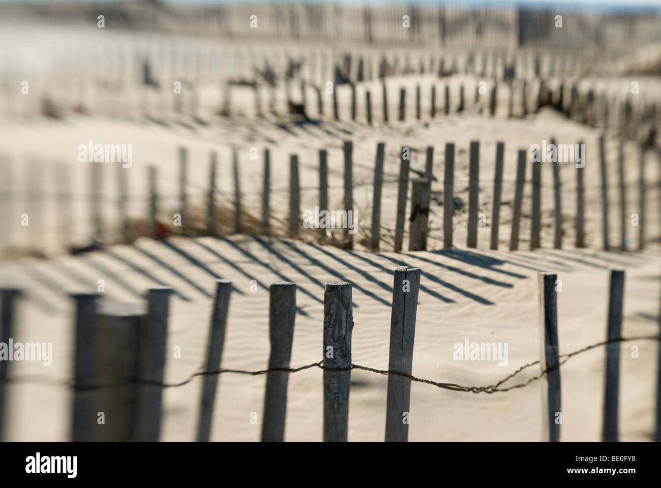 Slats of wooden fence throwing shadows on beach Stock Photo Alamy