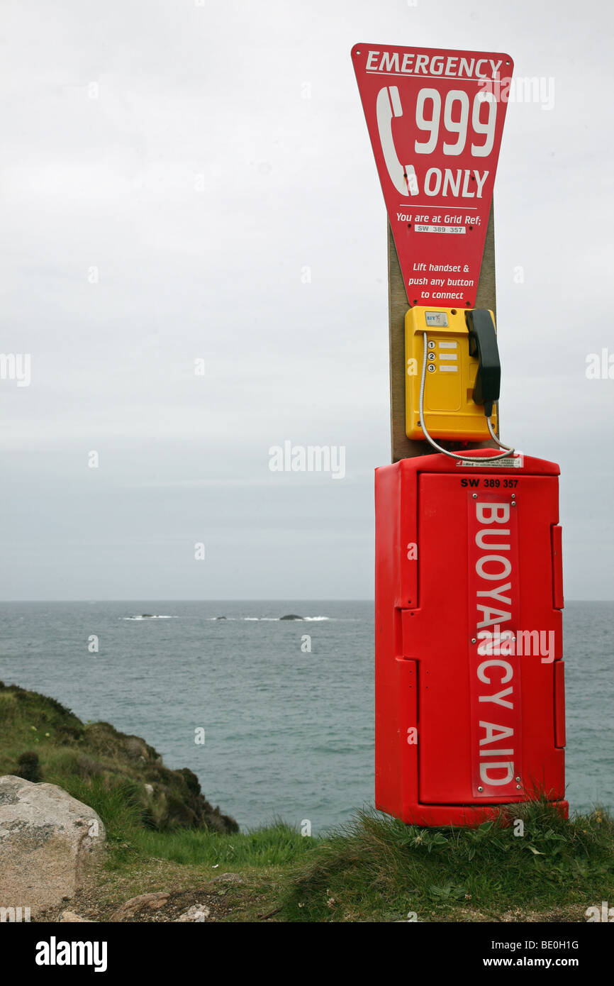 An emergency 999 buoyancy aid post rescue equipment with telephone on a cliff top at Portheras Cove Cornwall England UK Stock Photo
