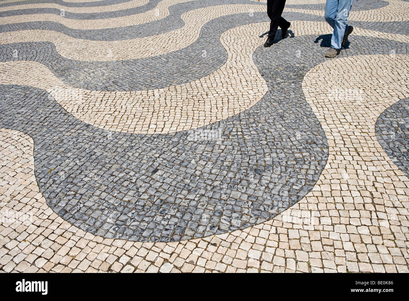 People walking on a typical Portuguese pavement, Portugal, Europe Stock Photo