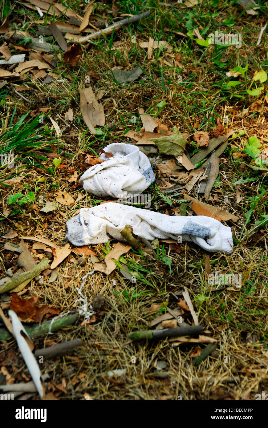 pair of socks old wet dirty and left behind Stock Photo