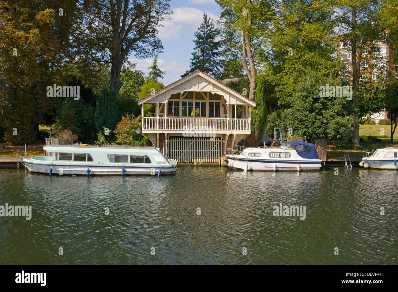 A Riverside Boathouse And Moored Boats On The River Thames at