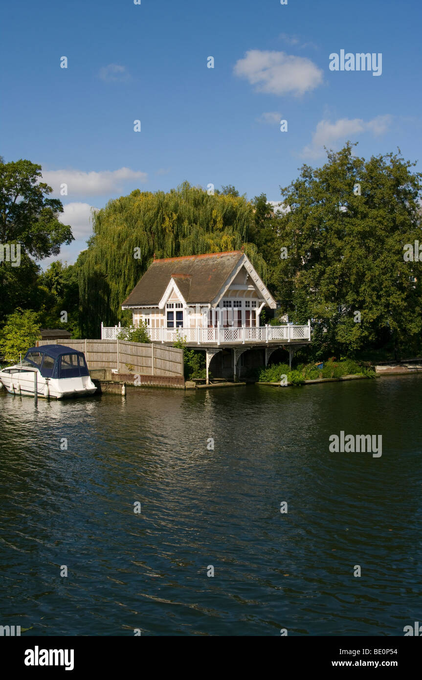 A Riverside Boathouse And A Moored Boat On The River Thames at