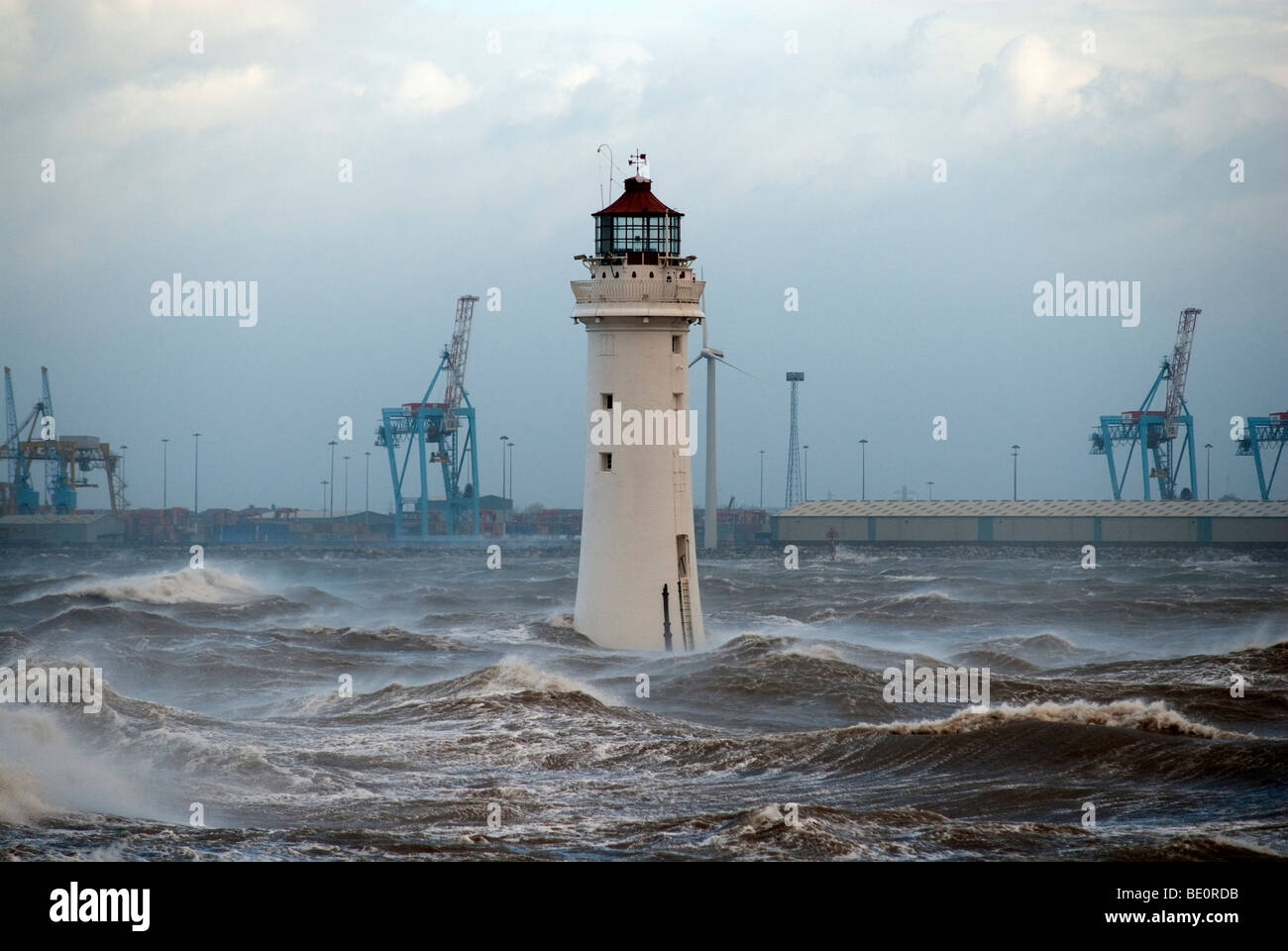 High winds and stormy seas at New Brighton, River Mersey UK with Lighthouse and castle Stock Photo