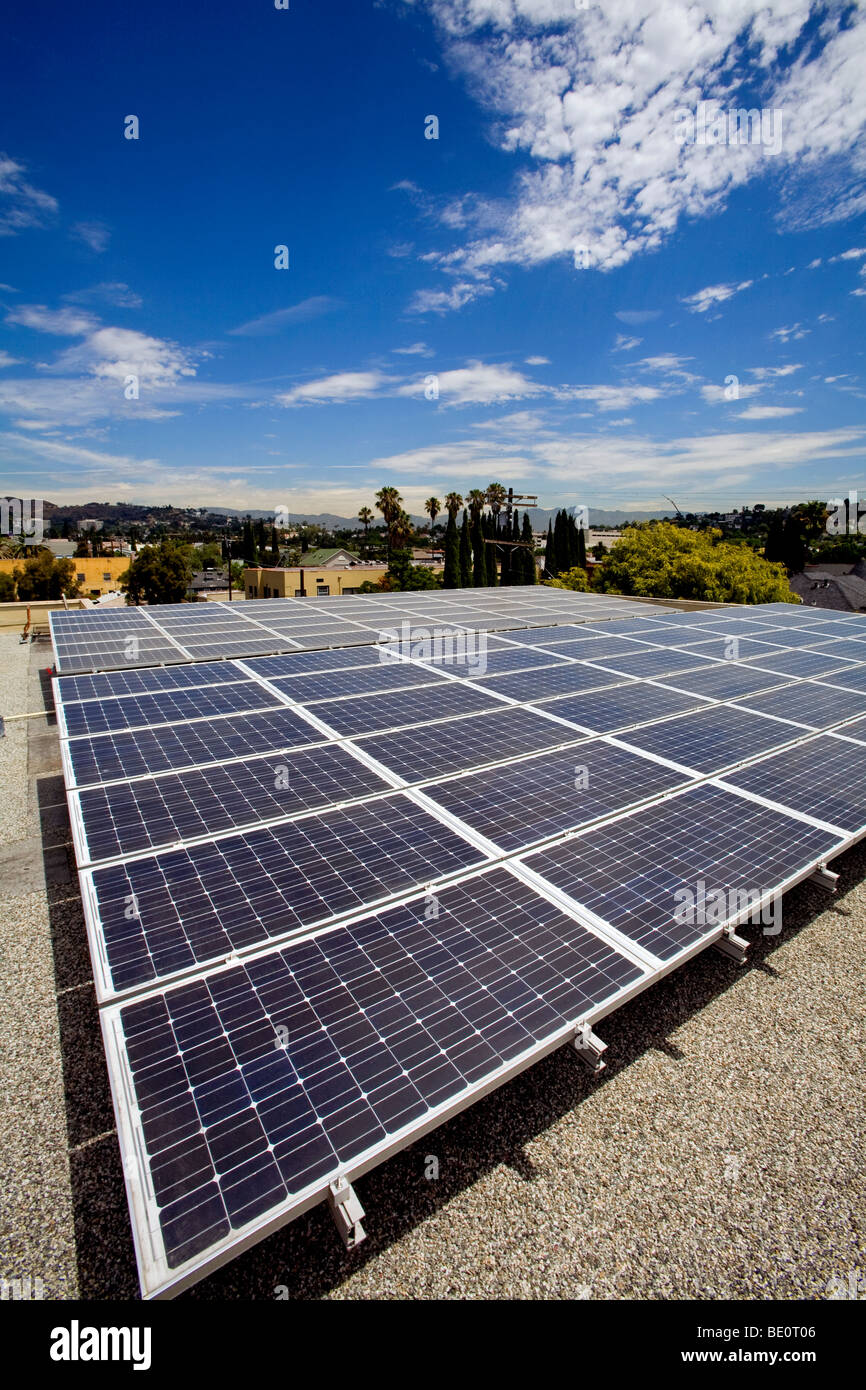 Solar array on rooftop of Asian Pacific Health Care offices with Hollywood Hills in background, Los Angeles, California, USA Stock Photo