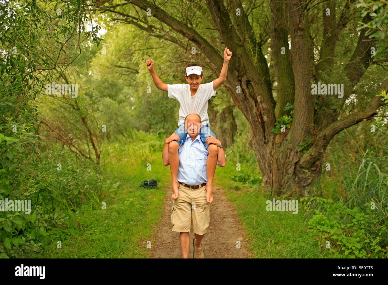 man carrying a young boy on his shoulders Stock Photo - Alamy
