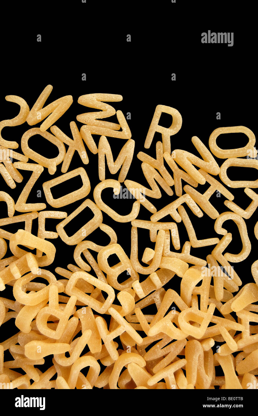 Alphabet soup pasta detail. Children's food background. Stock Photo