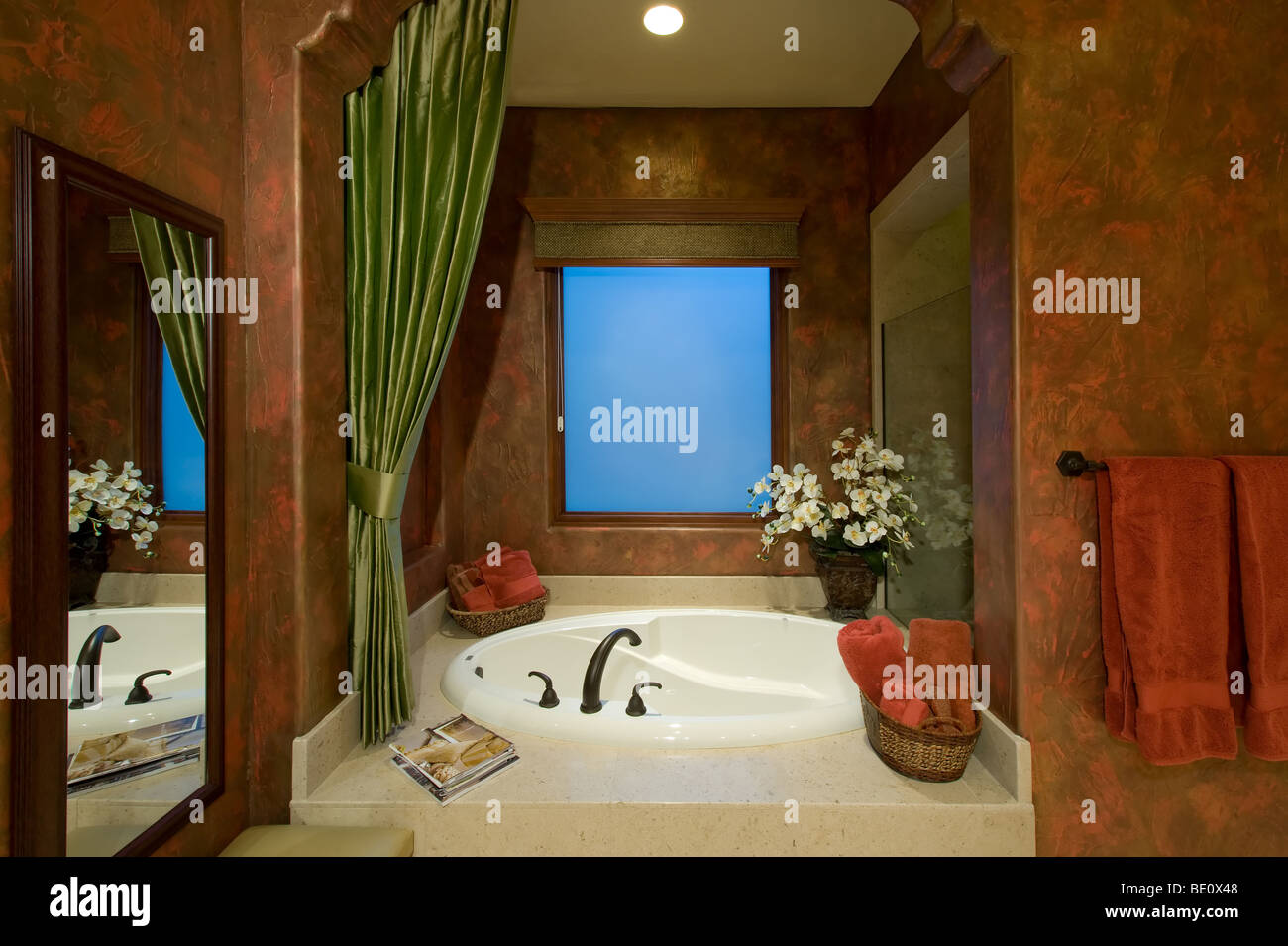 Soaker tub in richly colored master bath Stock Photo