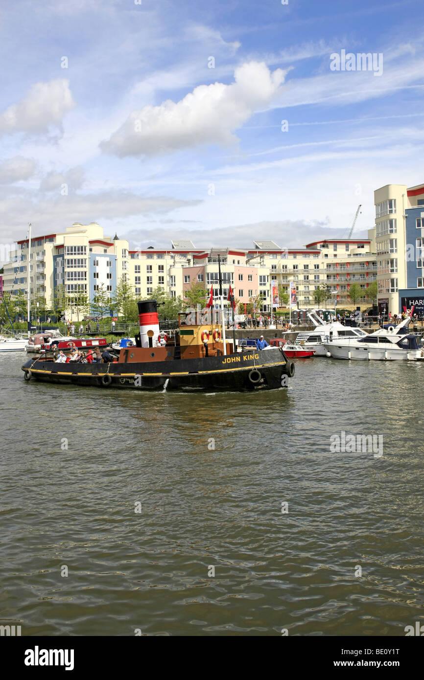 Old Tugboat "John King" in Bristol Harbour with modern development apartments in the background on old warehouse land Stock Photo