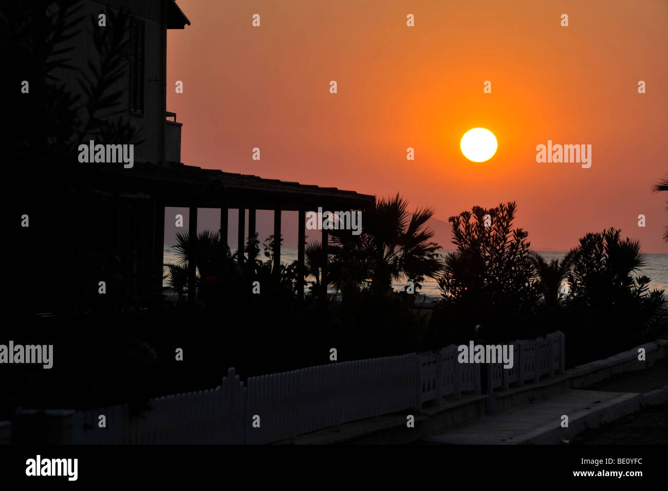 Sunset at the sea sisde with a holiday House in front Stock Photo