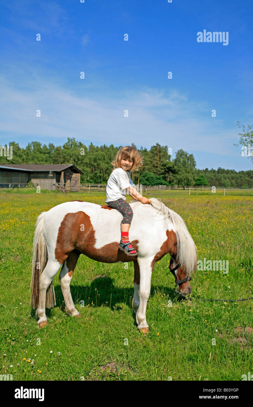 young girl riding a pony Stock Photo