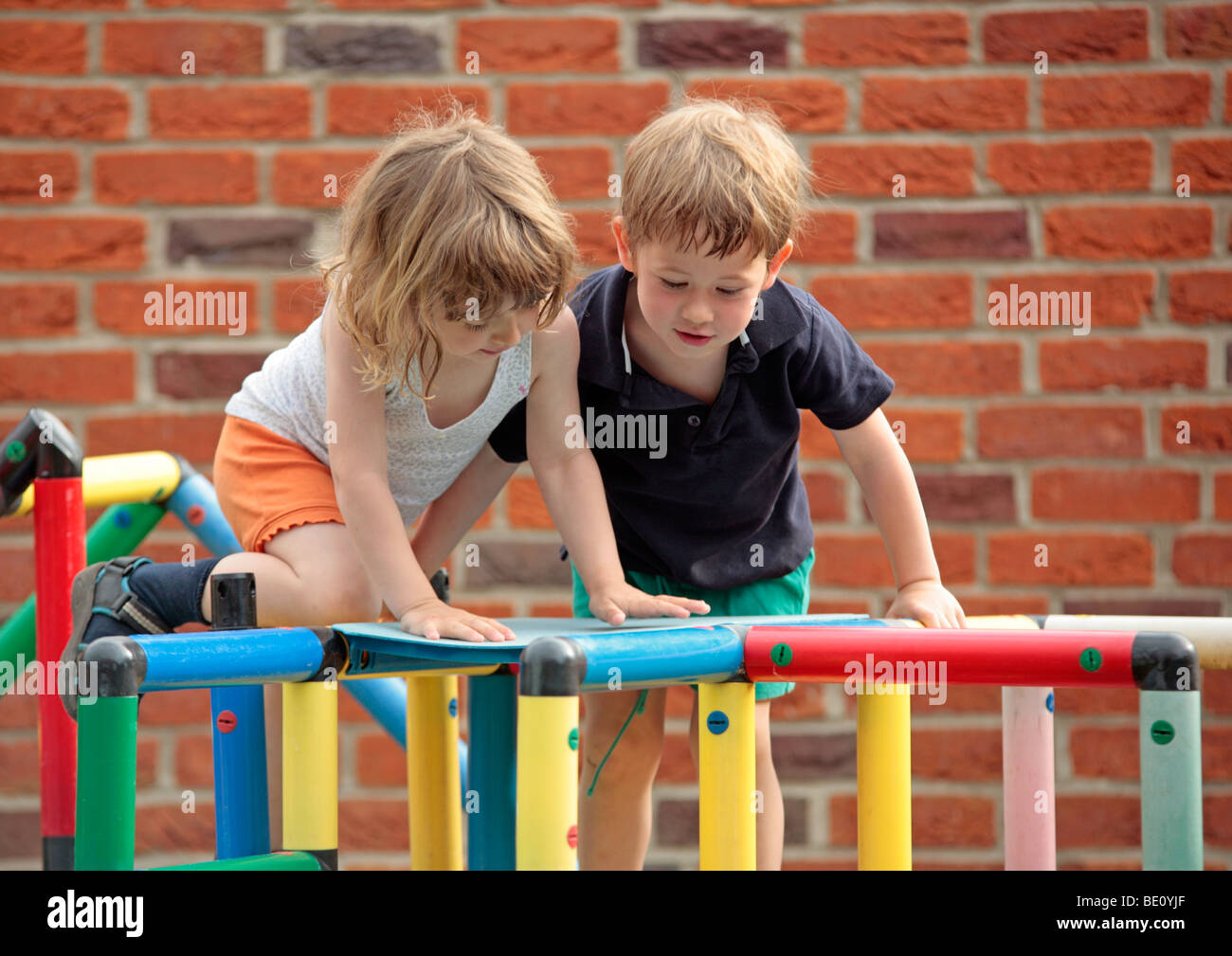 young children playing with a Quadro construction kit Stock Photo