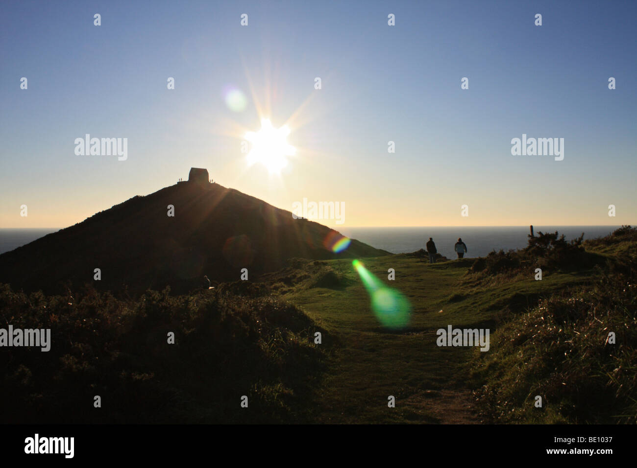 Walkers at St Michael's chapel at Rame Head southeast Cornwall, England ...