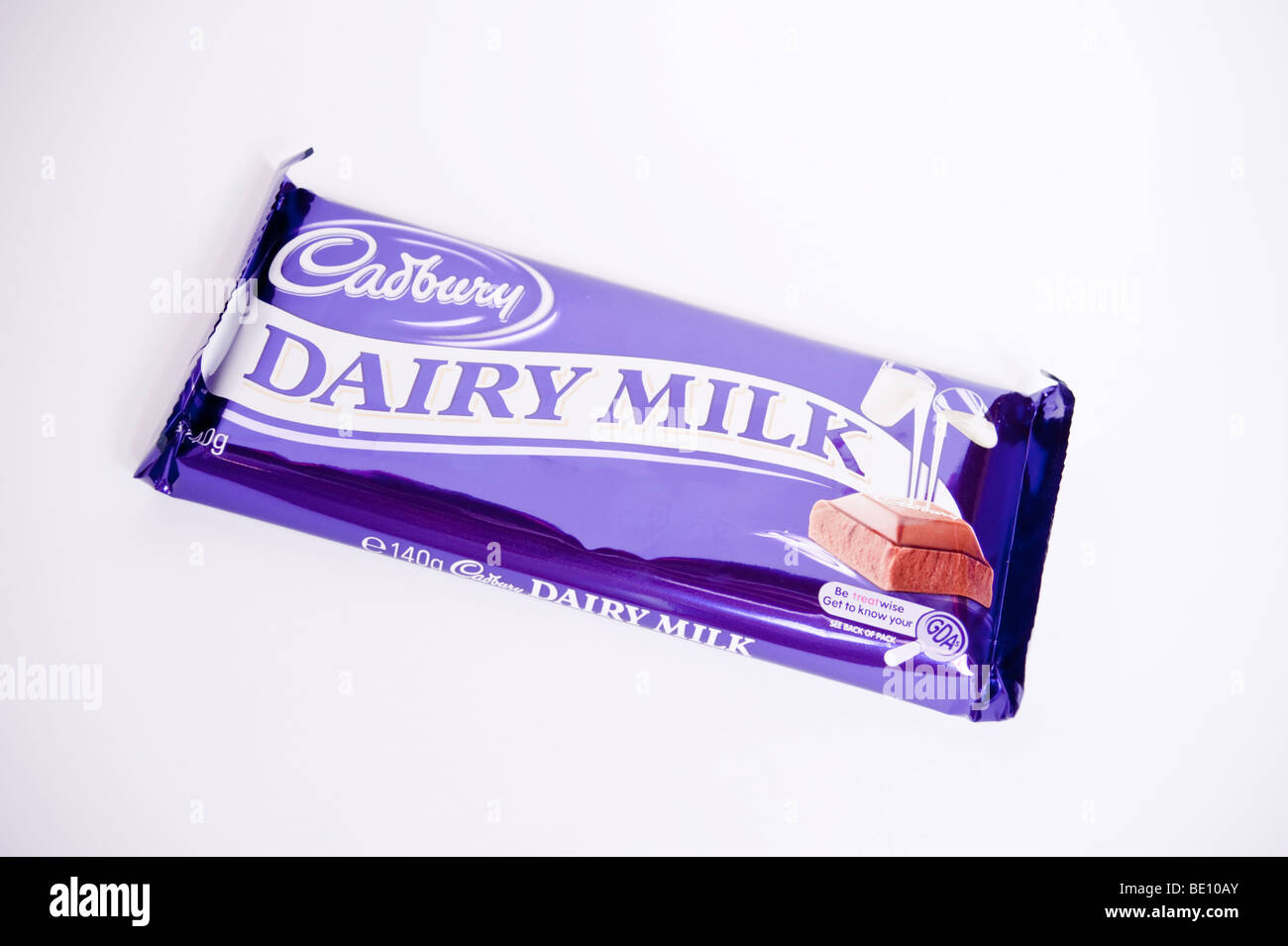 A close up of a bar of cadbury dairy milk chocolate on a white background Stock Photo