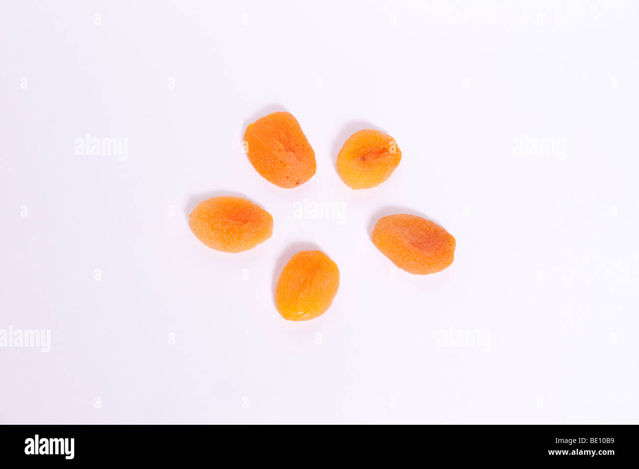 A close up of some dried apricots on a white background Stock Photo