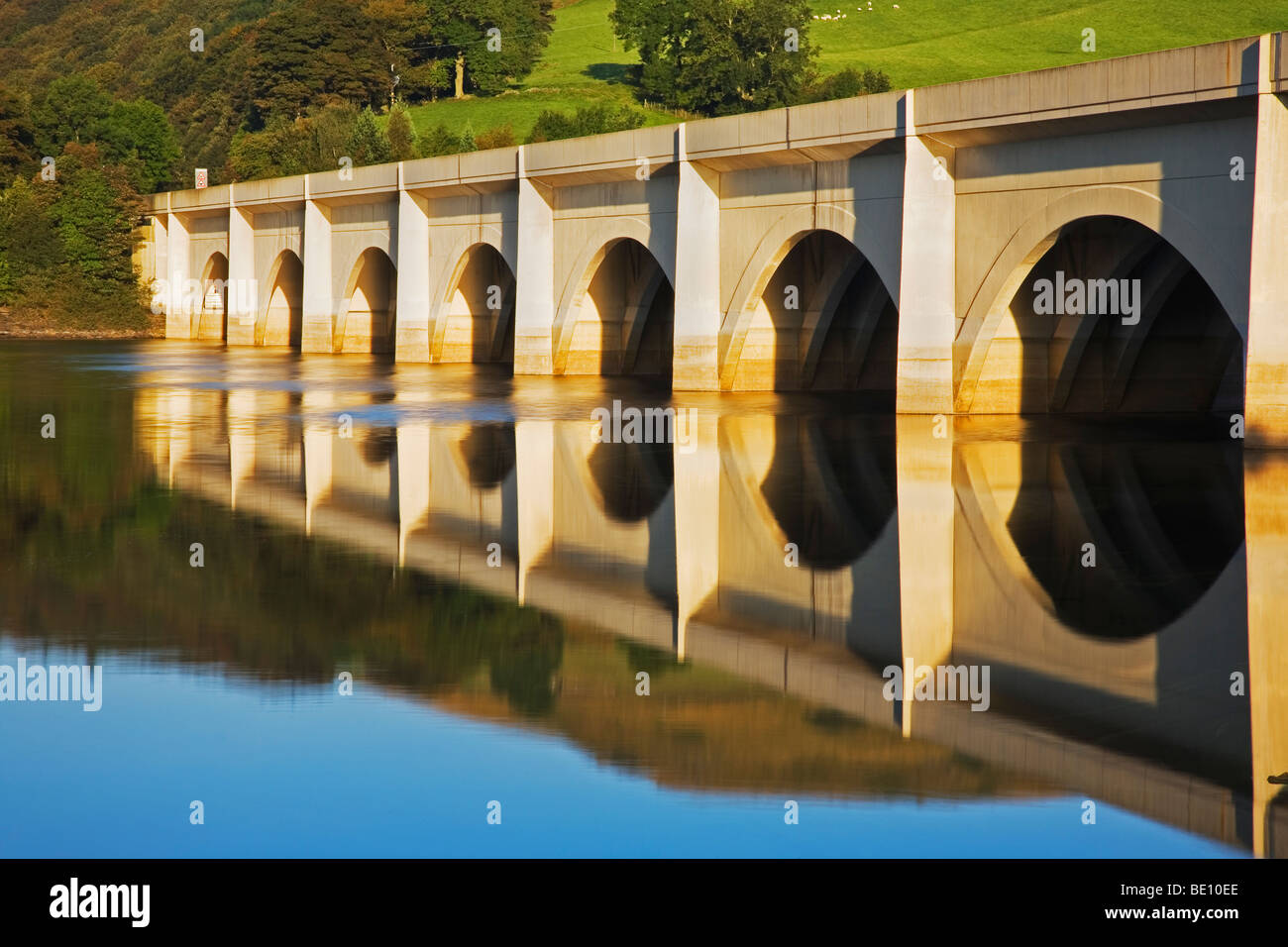 The Ashopton Viaduct, reflected in the still water of Ladybower Reservoir, one of the Derwent Dams at Ashopton, Derbyshire Stock Photo