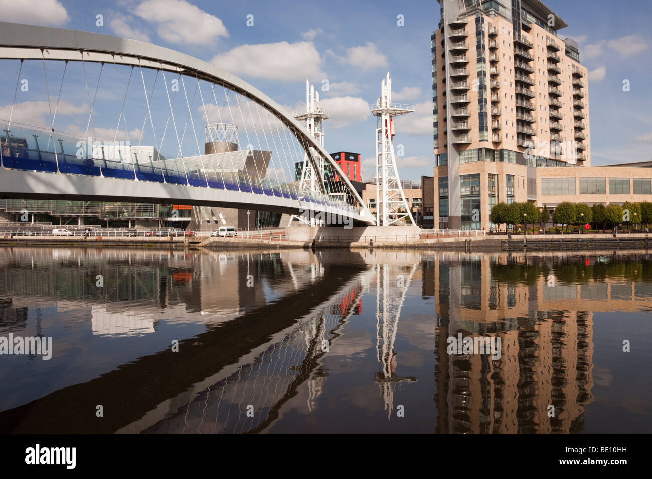 Salford Quays, Greater Manchester, England, UK. Lowry Millennium footbridge and Lowry Outlet Mall across Manchester Ship Canal Stock Photo