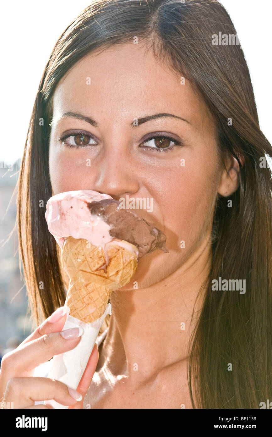 Young woman eating ice cream, Milan, Italy Stock Photo Alamy