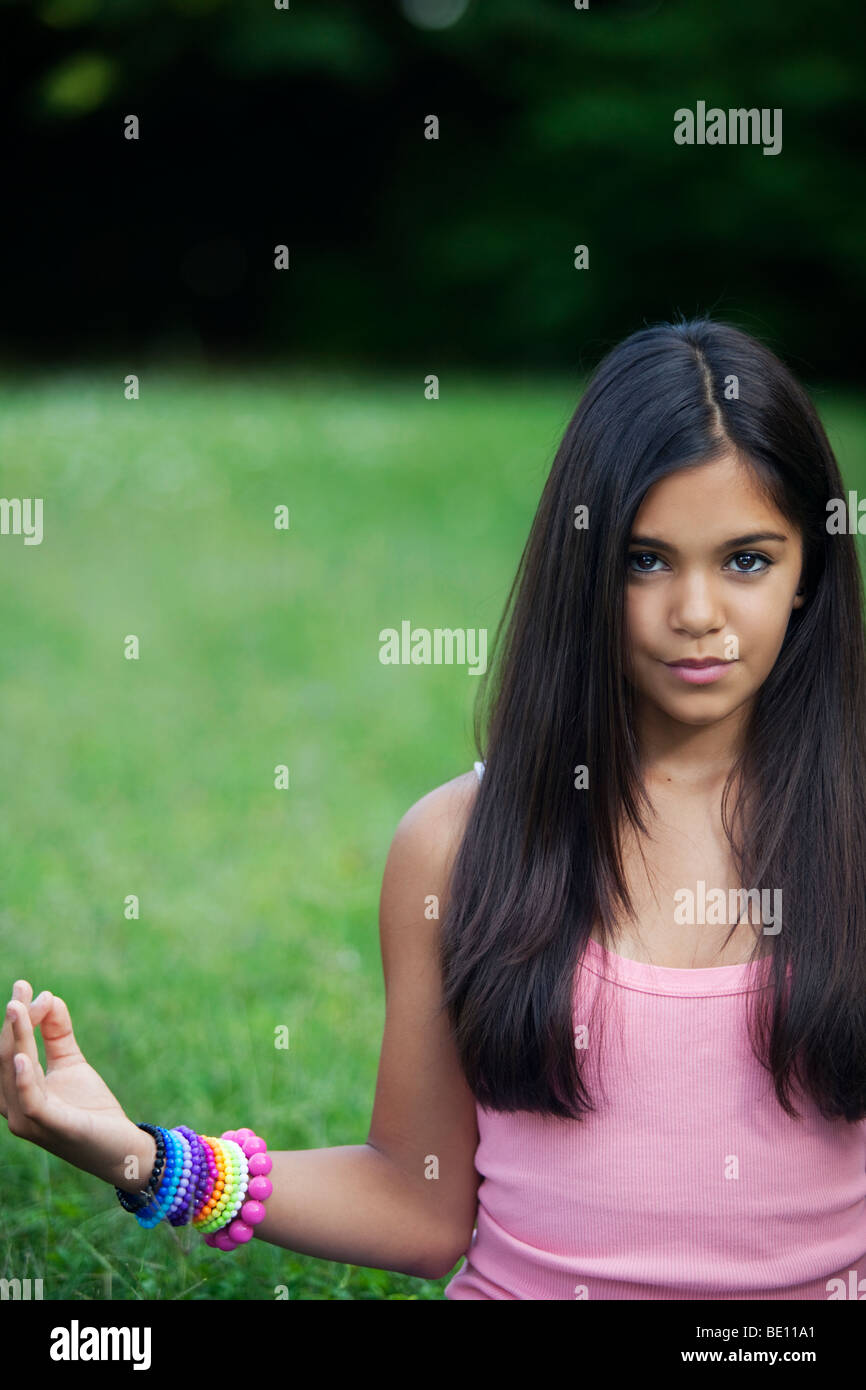 YOUNG TEENAGER GIRL DOING YOGA IN THE GARDEN Stock Photo
