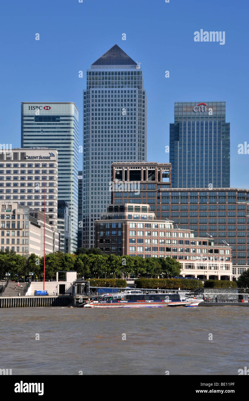 Canary Wharf skyline beyond River Thames with tour boat and clipper Stock Photo