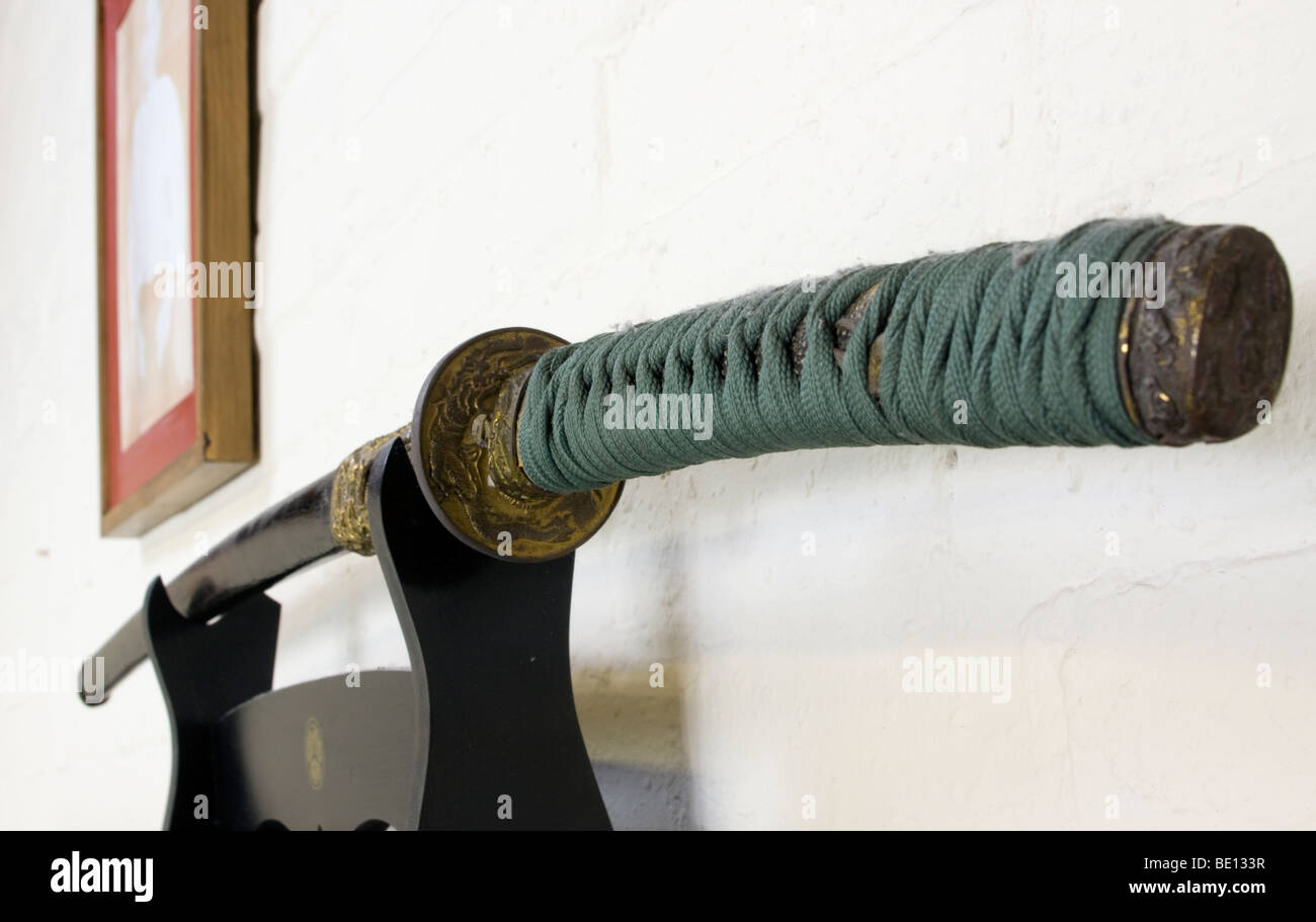 Japanese single edged sword katana in a kake kept in its scabbard (or