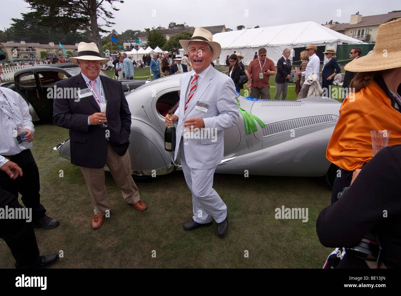Owners of a winning car drink champagne in front of the Lodge at Pebble Beach during the 2009 Pebble Beach Concours d'Elegance Stock Photo