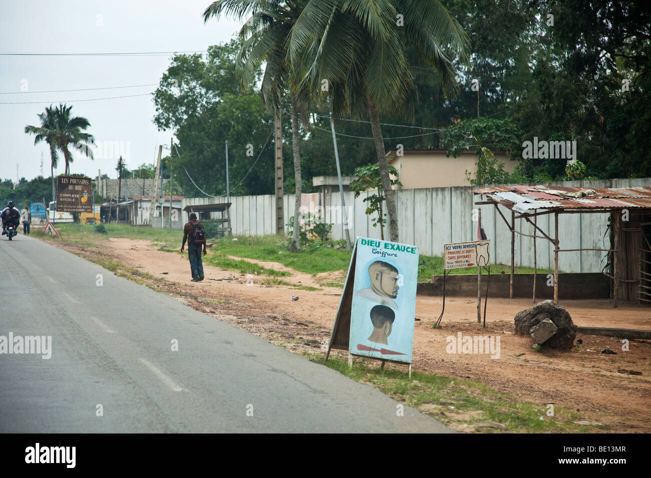 Signs line the streets of Cotonou, Benin. Due to high illiteracy rates, many signs advertise their services through pictures. Stock Photo