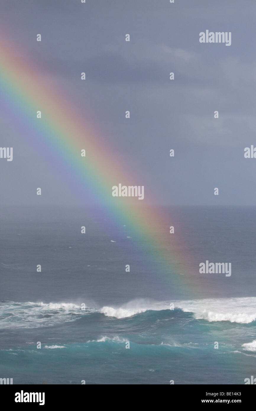 Rainbow over stormy seas Stock Photo - Alamy
