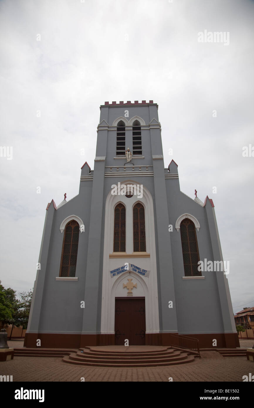 The Catholic Basilica in Ouidah, Benin sits across the street from the voodoo Temple of the Pythons. Stock Photo