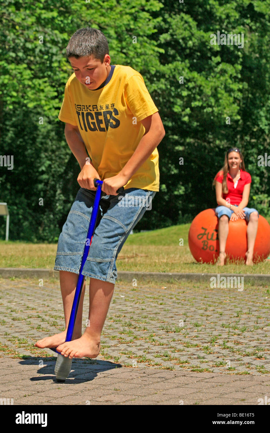 portrait of a young boy on a pogo stick Stock Photo Alamy