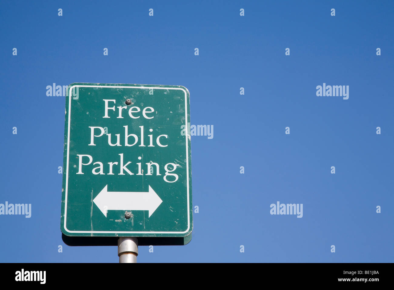 A close up of a Free Public Parking street sign against blue sky Stock ...