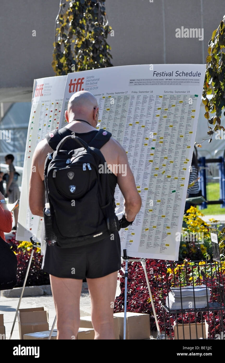 People, passers by studying the TIFF(Toronto International Film Festival Schedules) Stock Photo