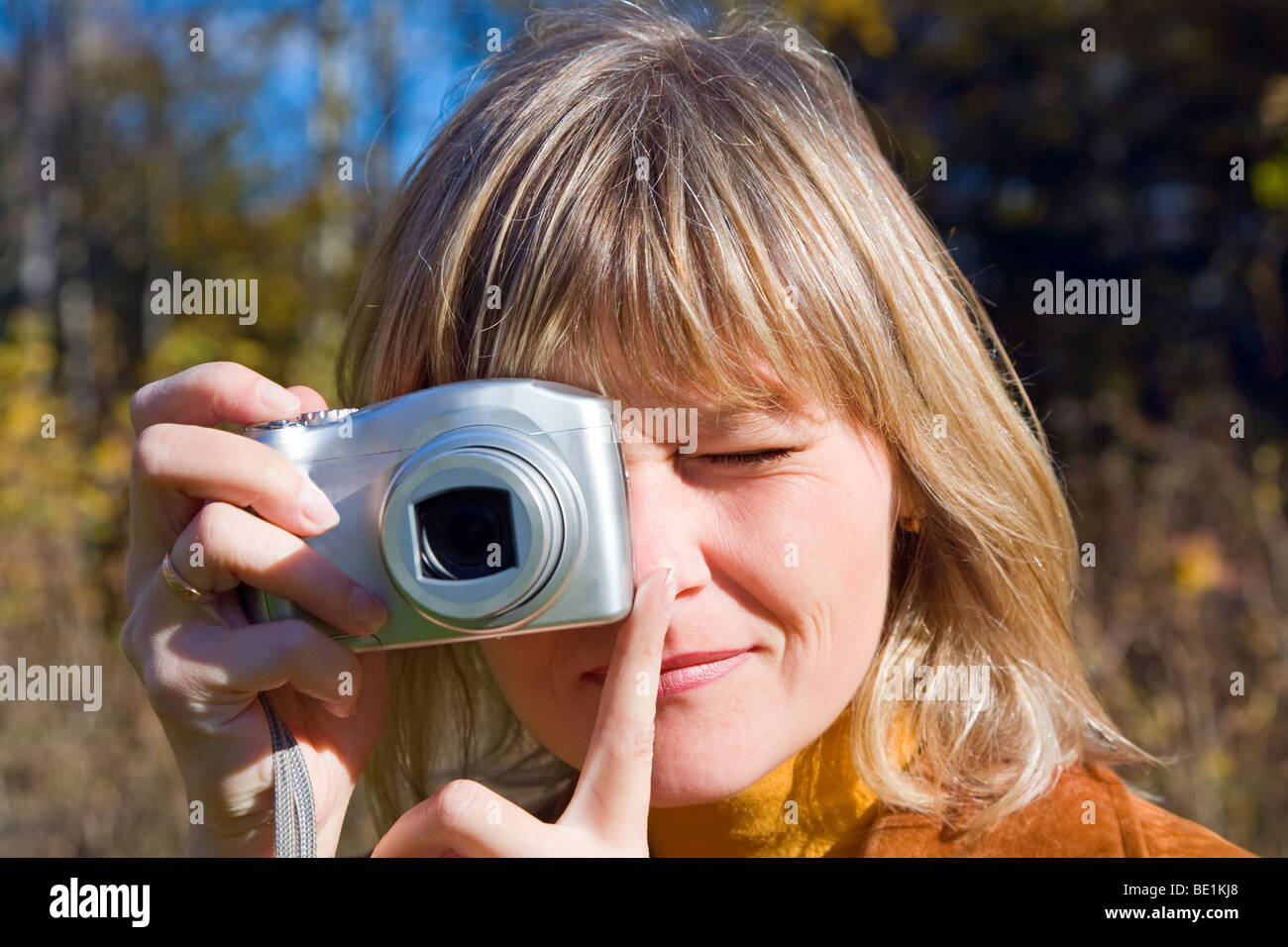 Young woman making photos using compact camera on autumn forest Stock ...