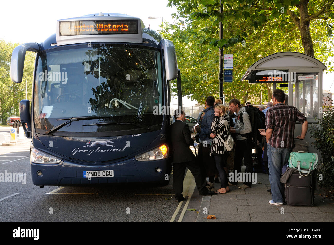 Passengers with luggage and a British Greyhound Lines bus named Proud Mary in Southampton on the first day of the new  service Stock Photo