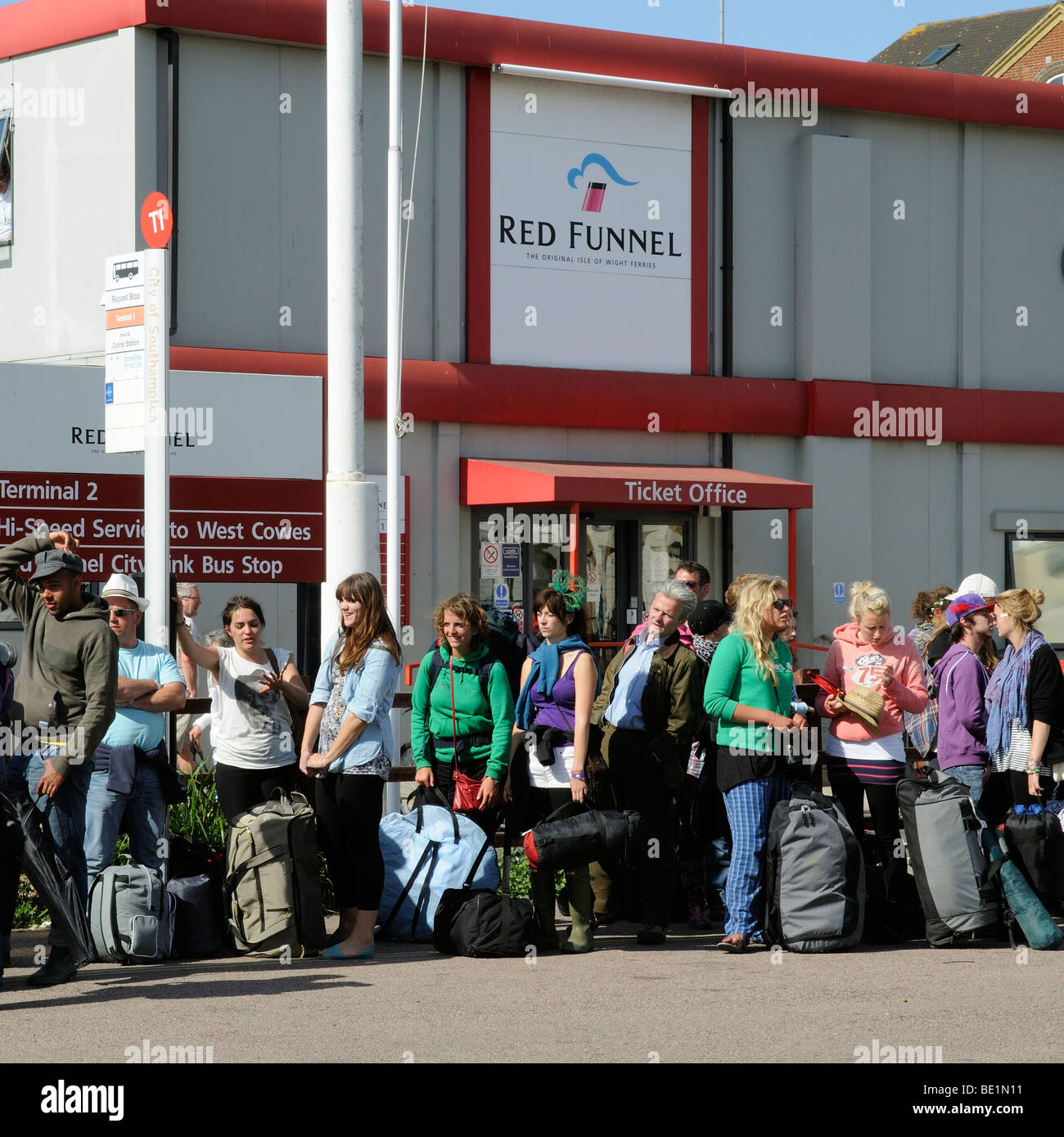 Crowded bus stop outside Red Funnel ferry ticket office and terminal building Southampton England UK Stock Photo