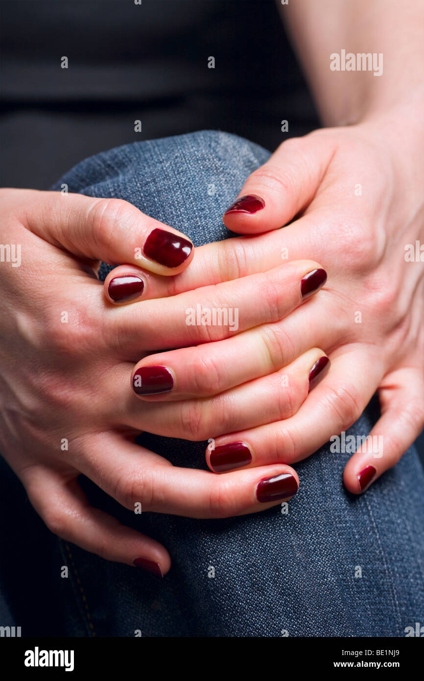 Close-up shot of clasped, manicured female hands Stock Photo