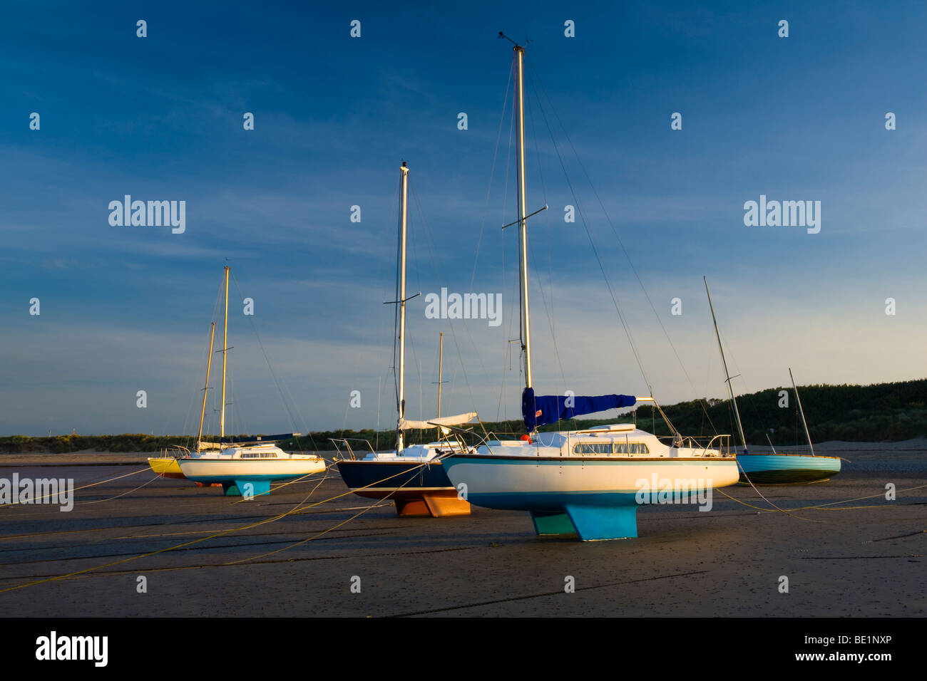 England, Northumberland, Beadnell. Small sailing boats moored in Beadnell Bay - viewed at low tide. Stock Photo