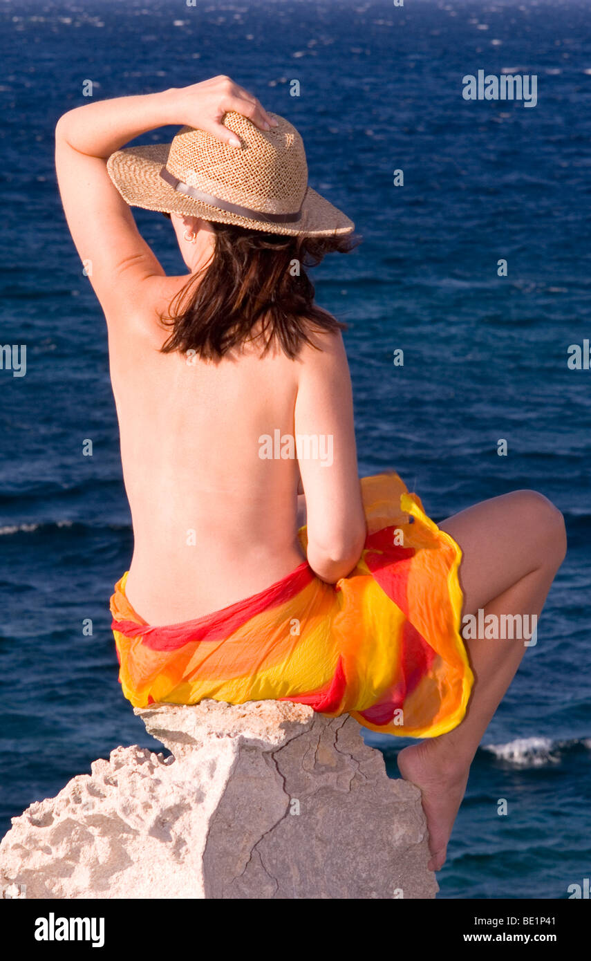 Young woman looking towards the sea Stock Photo