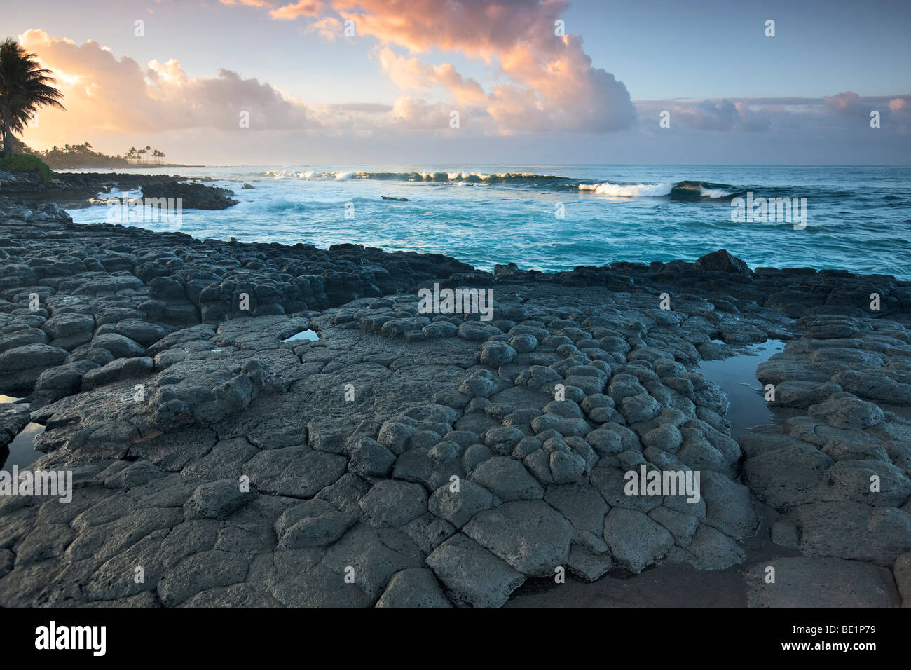 Basalt columns (columnar jointing) and sunrise, Poipu. Kauai, Hawaii. Stock Photo