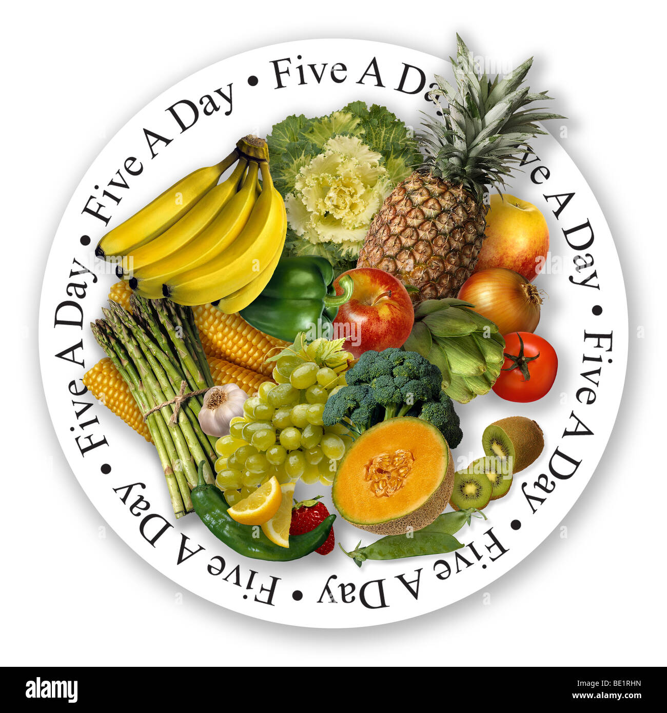 Fruit and vegetables on circular white plate with Five A Day written in black lettering around the outside of the plate. Stock Photo