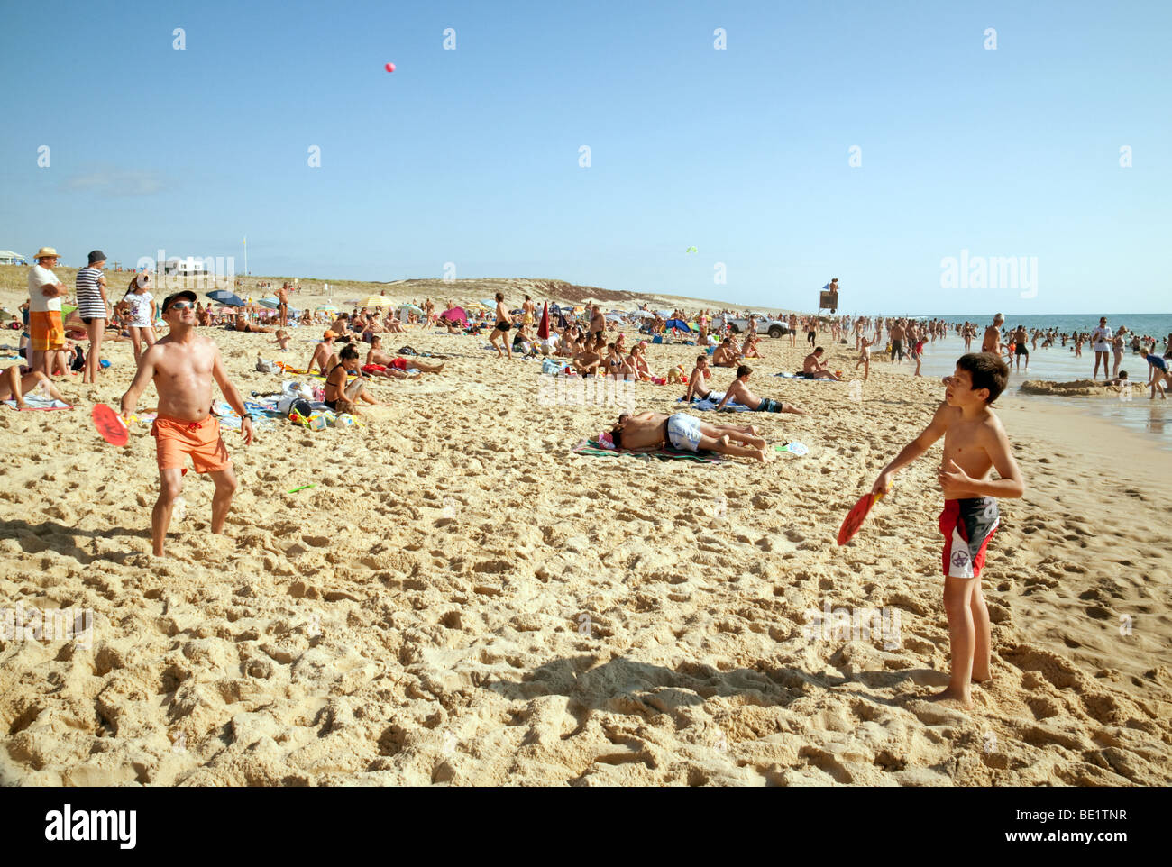 A father and sun playing beach tennis  on the beach at Biscarrosse, Aquitaine, France Stock Photo
