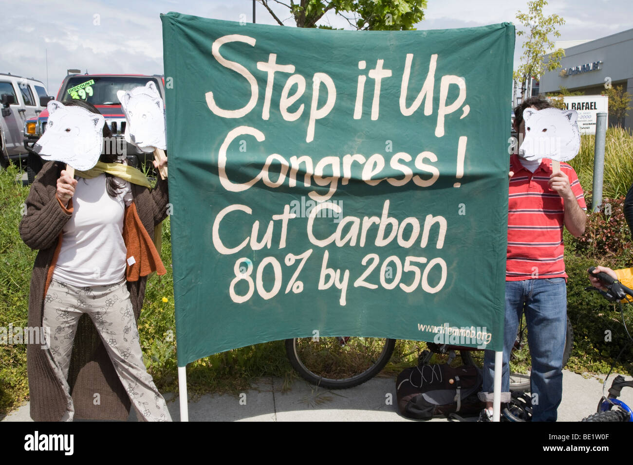 American protesters with polar bear masks holding banner asking Congress to cut carbon emissions 80% by 2050. California, USA Stock Photo