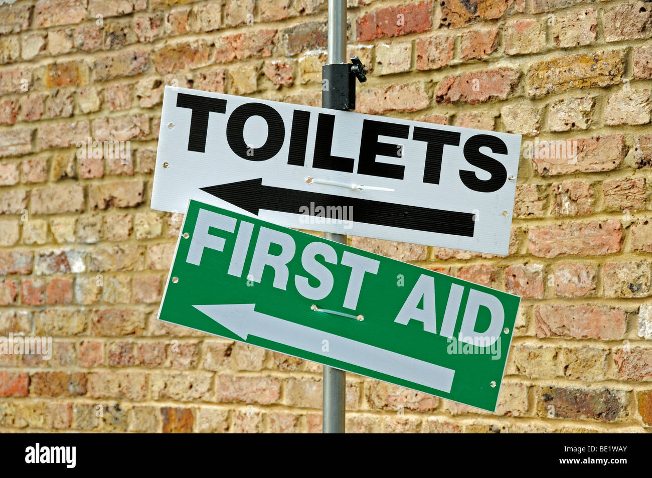 Toilets and First Aid  direction signs at the Angel Festival Islington London England UK Stock Photo