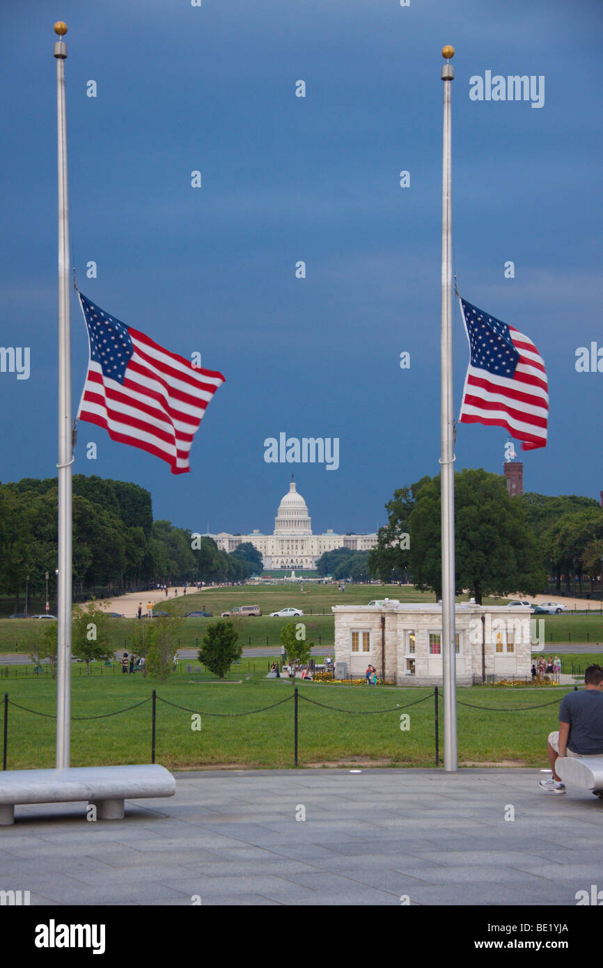 Flags at halfmast near the Washington Monument, with the US Capitol in