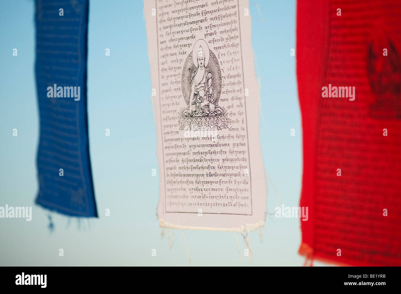 Buddhist prayer flag against blue sky. India Stock Photo